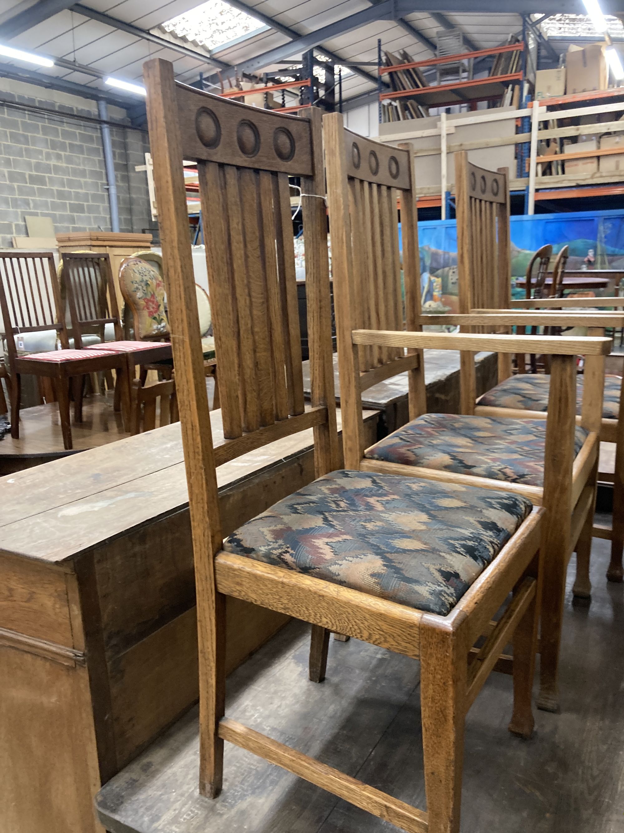 A set of six Arts & Crafts style oak dining chairs (two with arms)